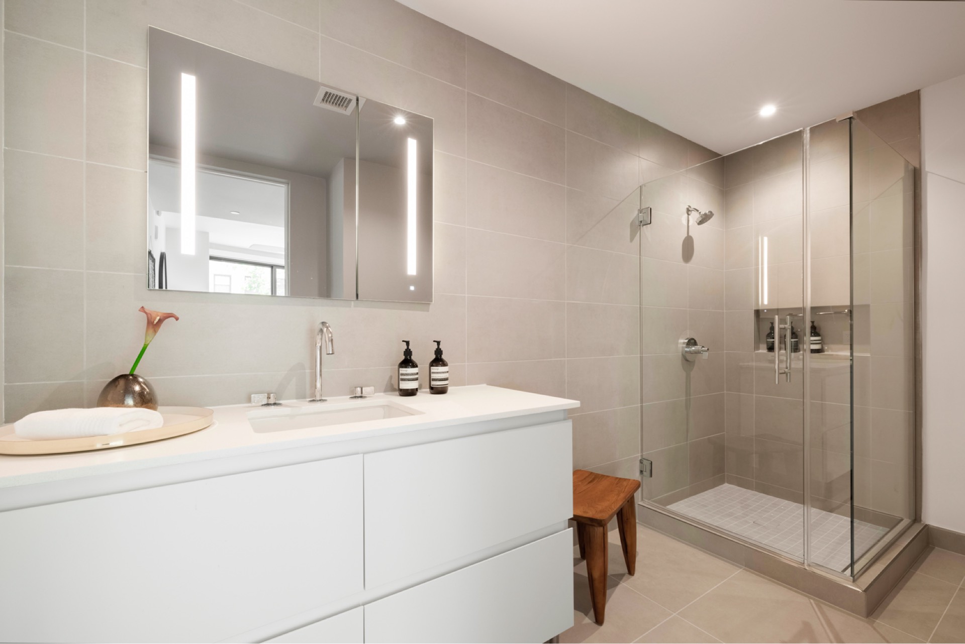 Porcelanosa® tile, Robern® medicine cabinets, and Kohler® fixtures in bathrooms